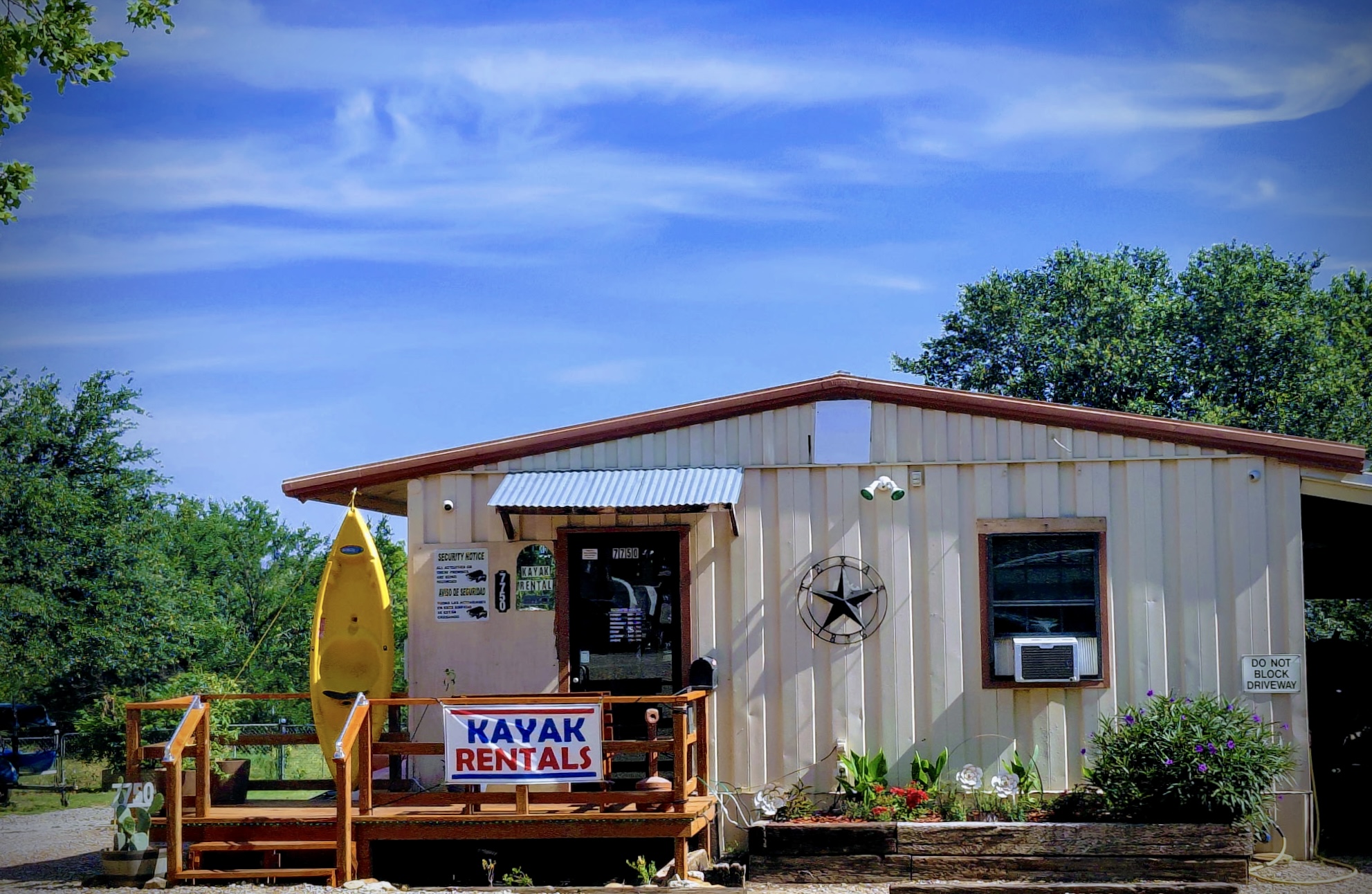 The ranch office building with kayak rentals and a Texas star out front